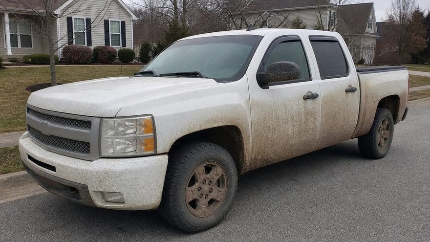 Sedan before detailing — dusty and neglected.
